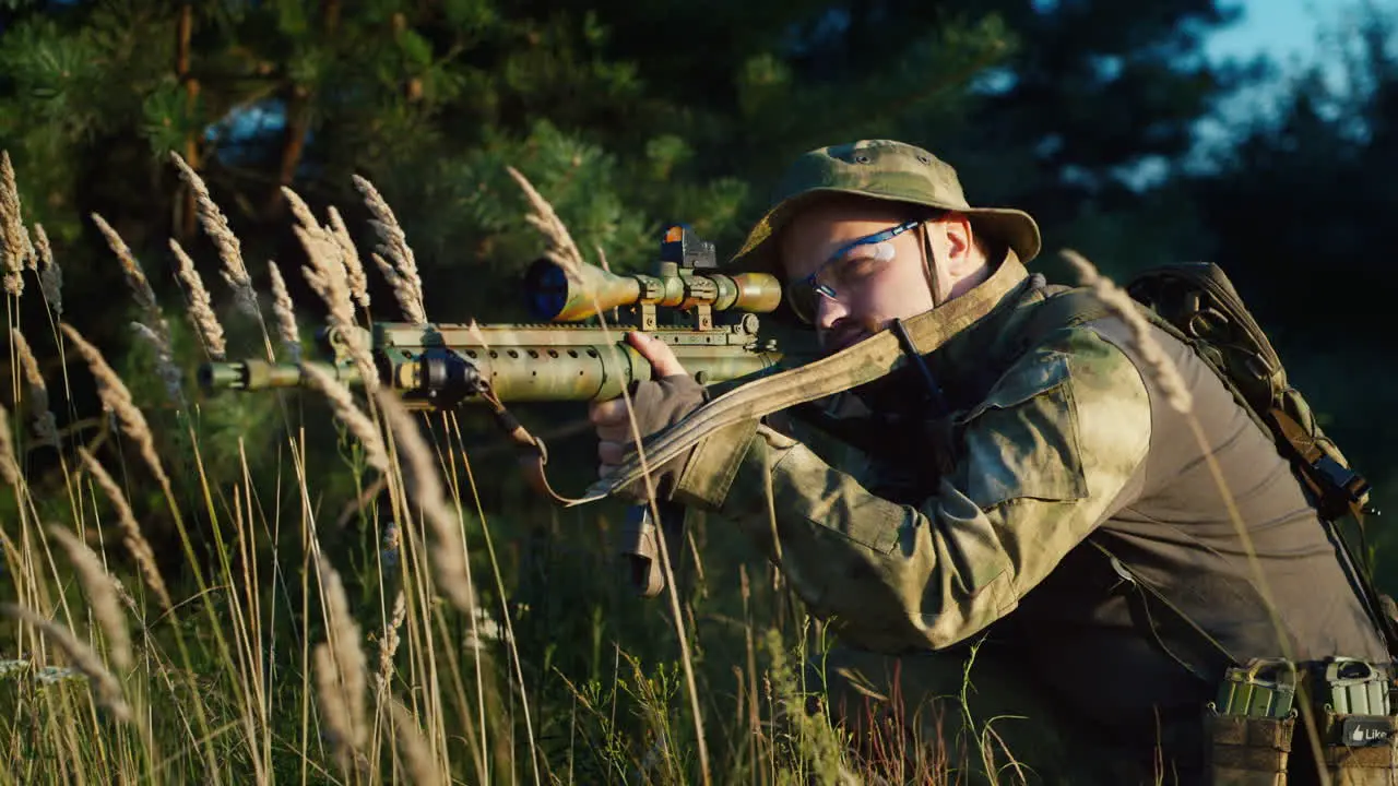 A solider aims his rifle