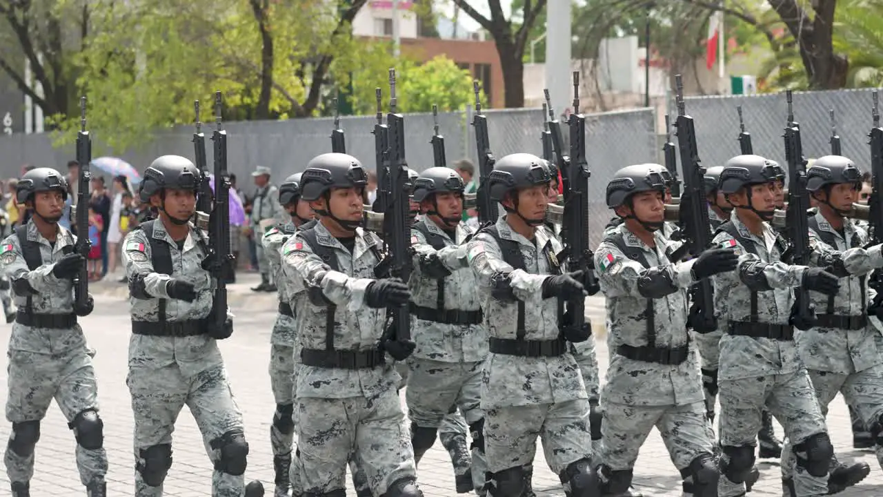 Heavy armed mexican soldiers marching on parade in Monterrey during independence day