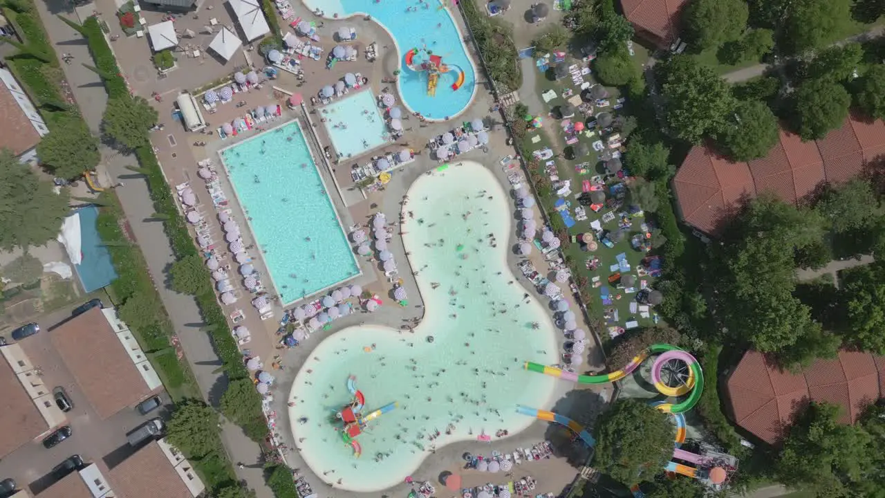 Birds eye view drone shot outdoor swimming pools on hot summer day