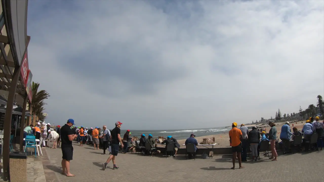 Time lapse of people walking on a walkway next to the beach in Namibia