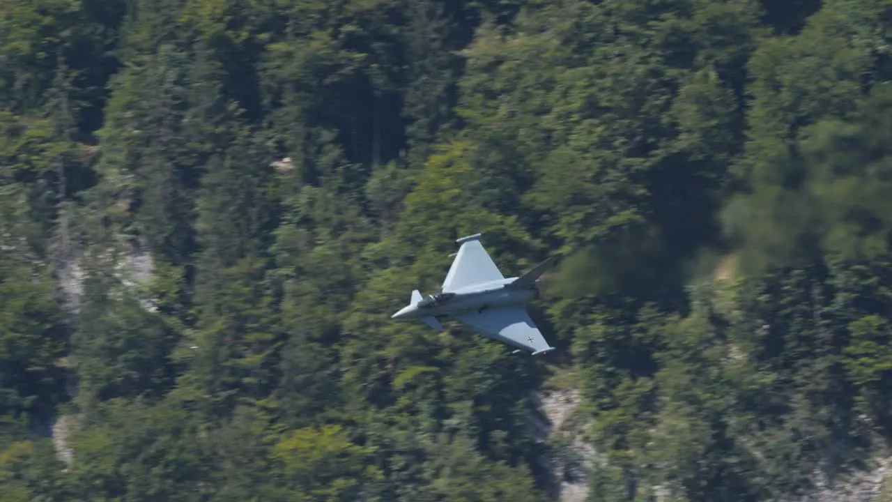 Speed of Eurofighter Typhoon in low altitude with Switzerland landscape in background