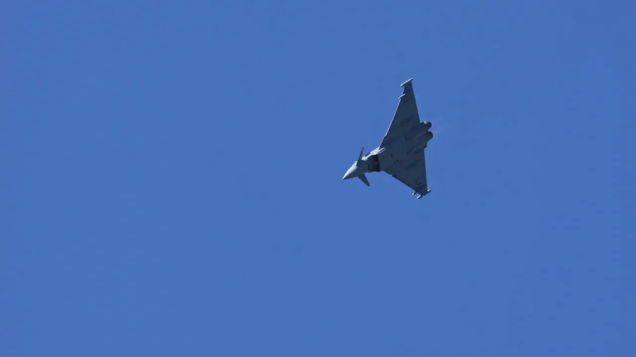 Eurofighter typhoon show up in mountain region of Switzerland handheld view