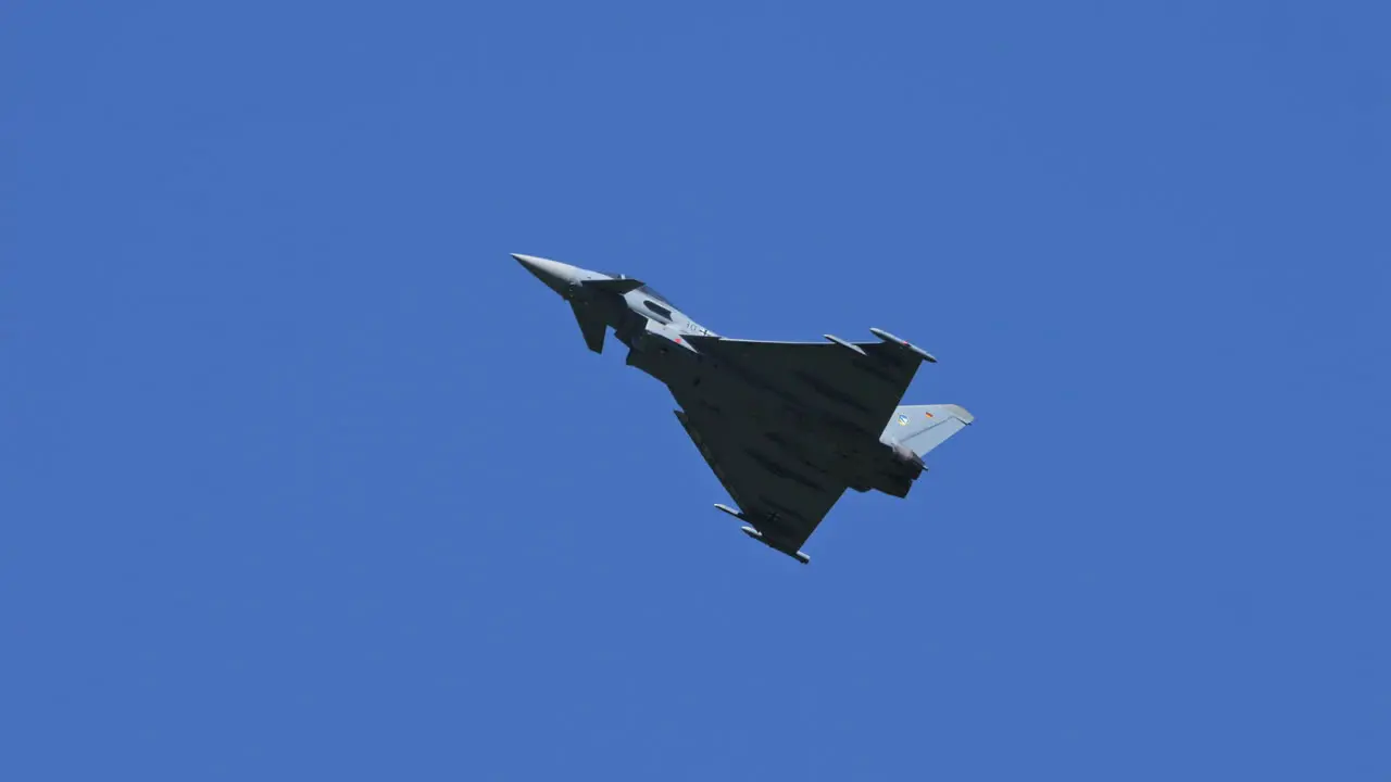 German Eurofighter Typhoon against blue sky follow view