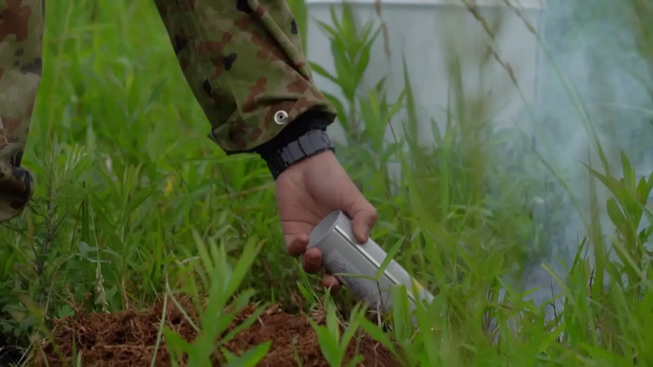 Japanese Ground Self Defense Force (Jgsdf) Soldier Lights A Smoke Grenade In Preparation For A Paratrooper Jump At Yokota Air Base Japan