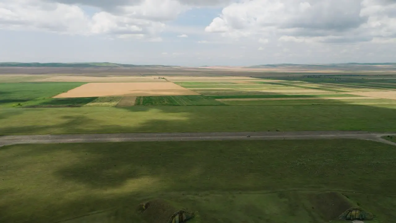 Car driving on Shiraki military airfield runway in georgian fields