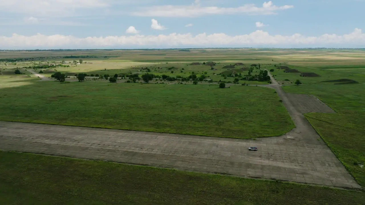 Car parked on Shiraki military airbase runway in georgian fields