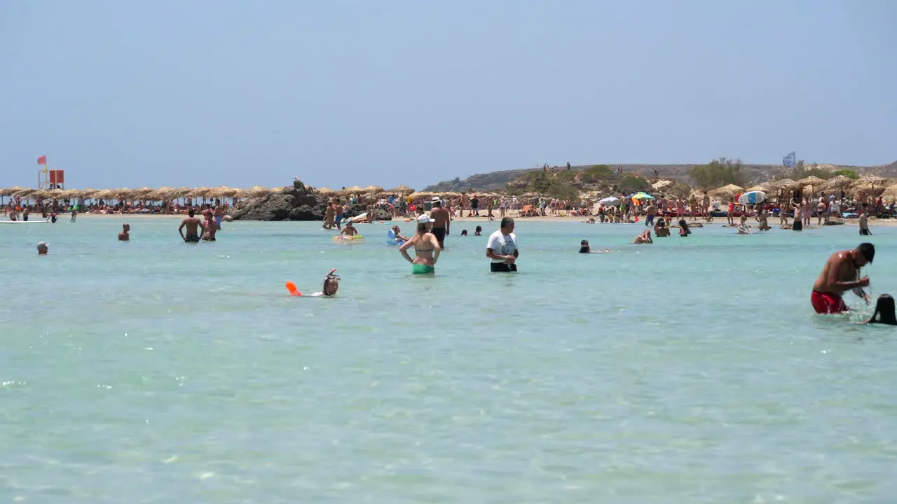 People swimming in the clear waters of Elafonissi Beach Crete