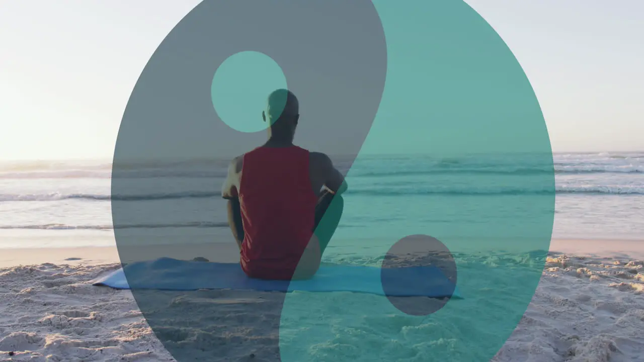 Animation of ying yang symbol over senior african american man sitting on sunny beach