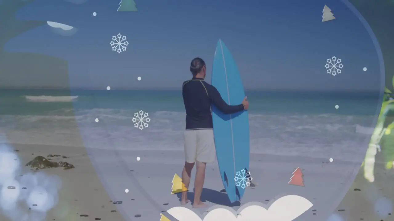 Animation of snowflakes and trees over back view of caucasian male surfer on beach