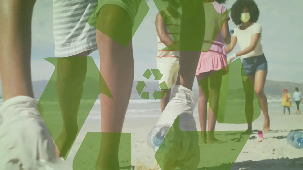 Animation of recycling icon over african american family picking waste on sunny beach