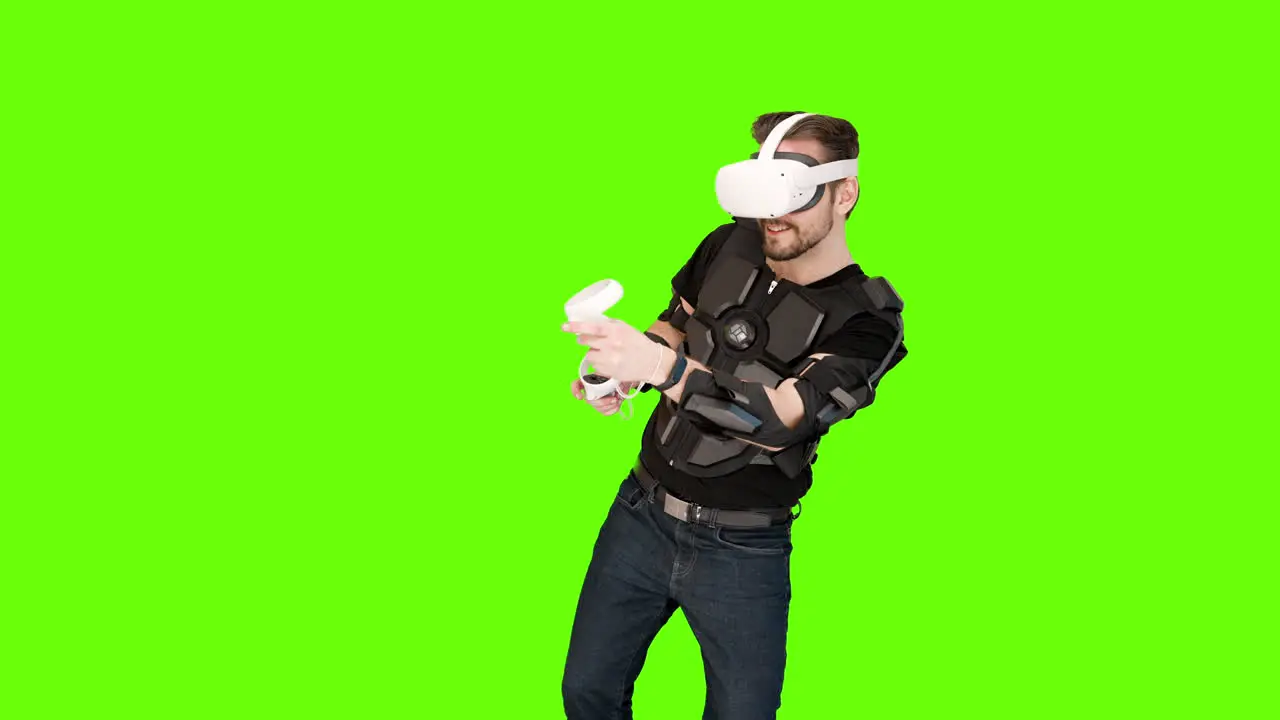 Man in white VR virtual reality oculus headset computer tracking shooting aliens mixed augmented immersive green screen aiming nerdy gamer game futuristic happy exciting future entertainment advanced