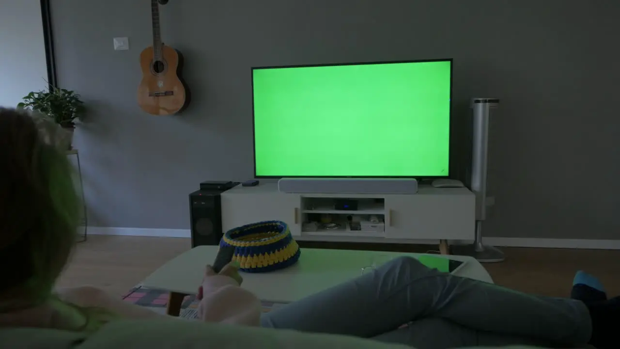 Green Screen TV Watching at Home with the Remote Control in hand