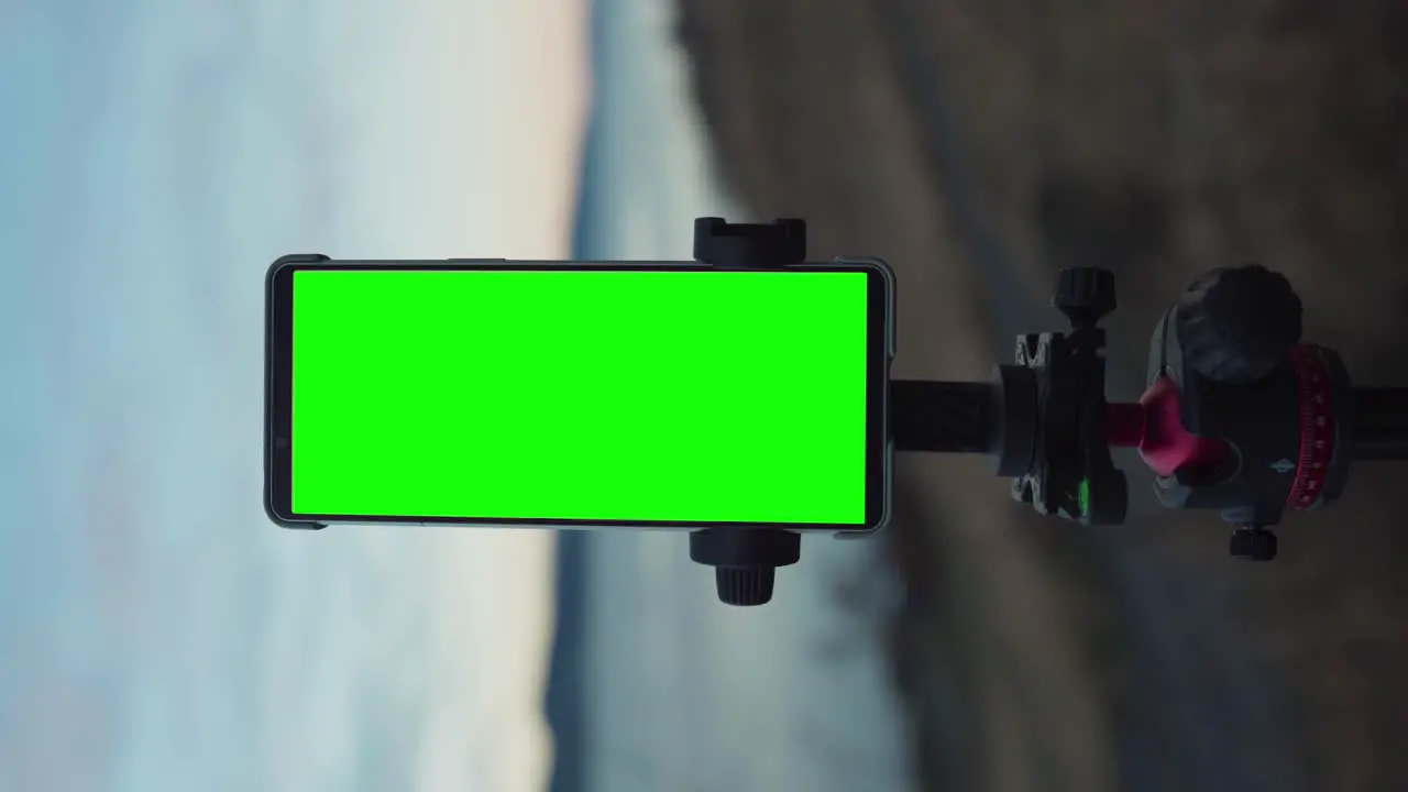 Vertical Smartphone With Green Screen Mounted On Tripod Stand Outdoor