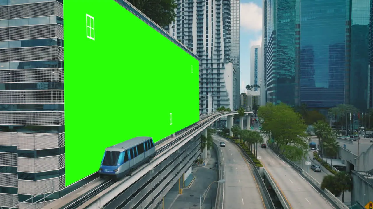 Urban train passing a green screen placeholder wall in a modern city 3D render