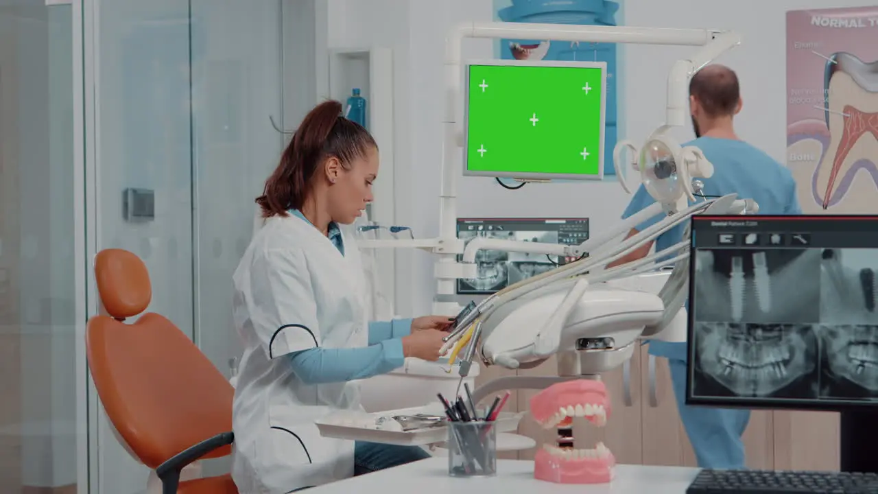 Woman using horizontal green screen on monitor