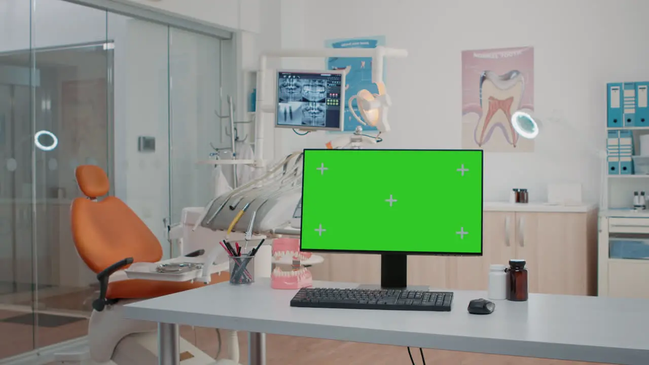 Nobody in dental cabinet with green screen on computer