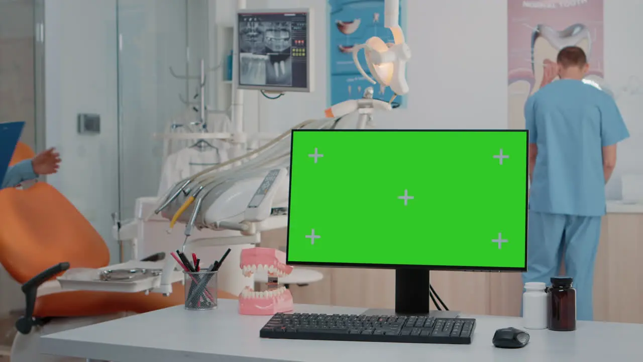 Monitor with green screen on desk in dentist office