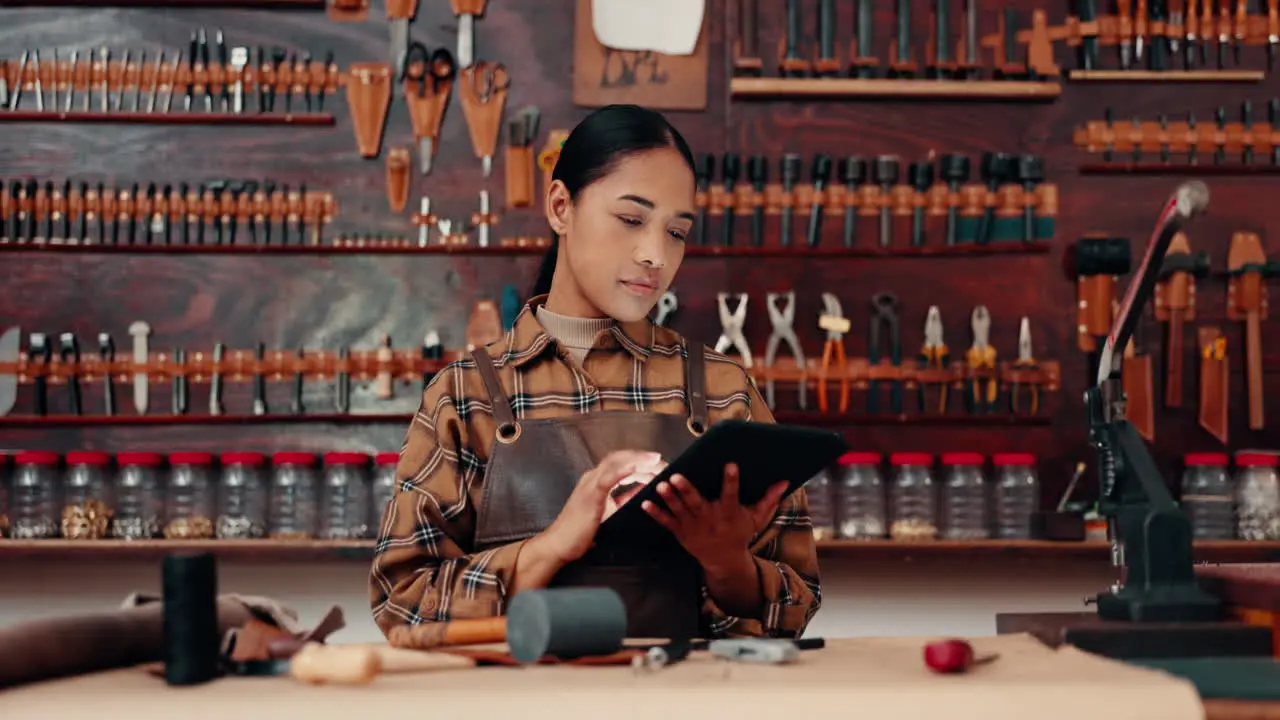 Leather work portrait of happy woman with tablet