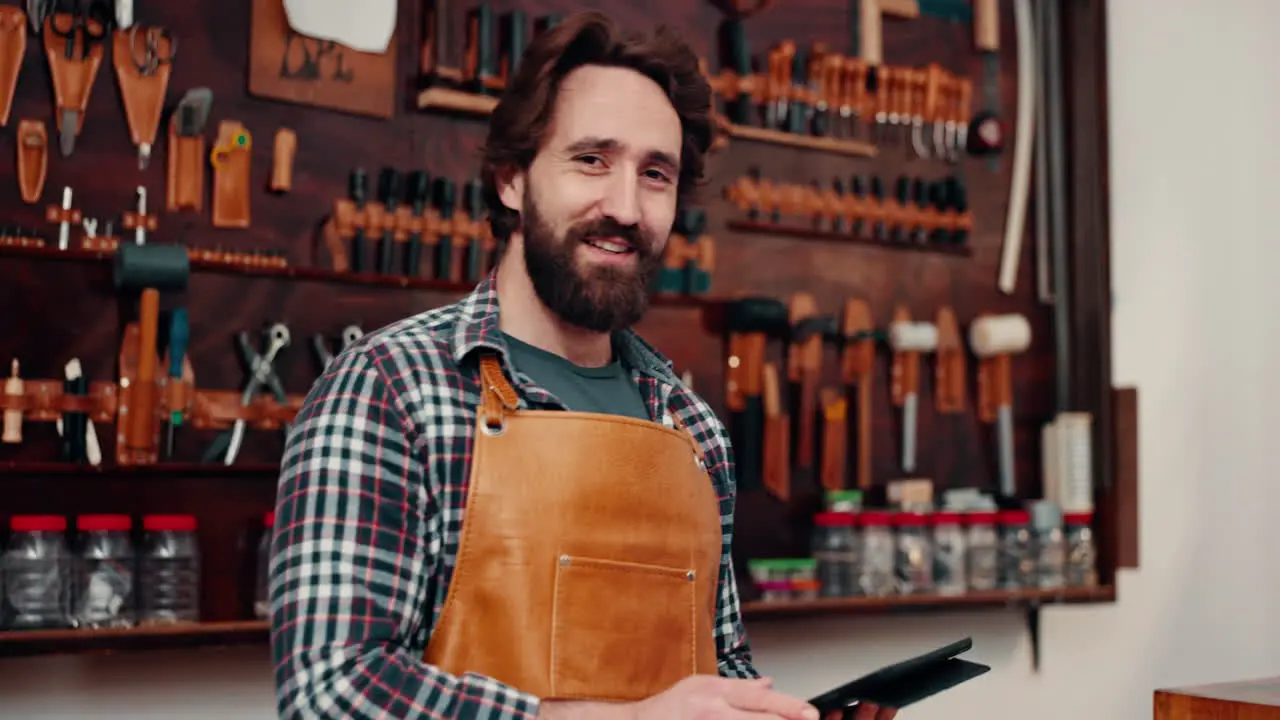 Leather workshop portrait of happy man