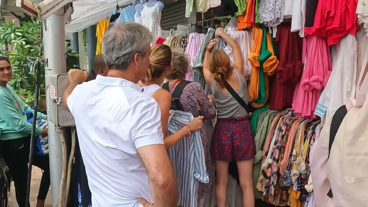 Mumbai India 20 August 2023 Tourists looking through clothes for sale at a market in Mumbai near the Gateway of India