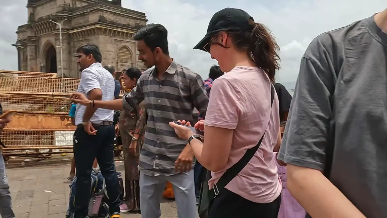 Mumbai India 20 August 2023 Friendly tourists and locals taking photos of each other near the Gateway of India in Mumbai India