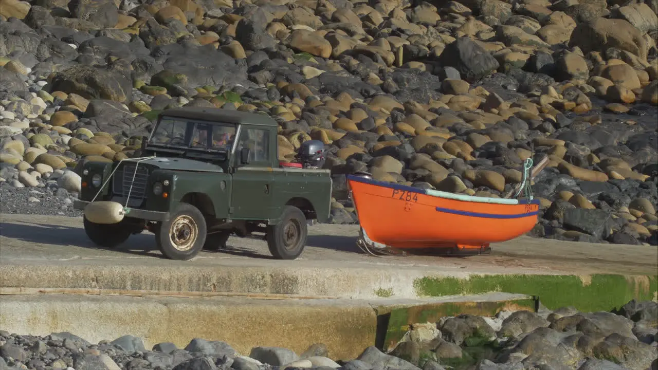 Fisherman hooks boat to truck on boat ramp after day on the water