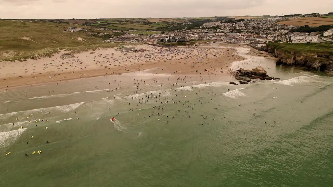 Perranporth Beach Packed Full Of Summer Surfers and Holiday Makers Cornwall UK Aerial View