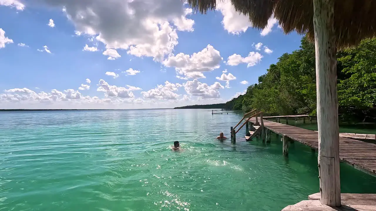 Carefree Tourist Diving into Tropical Tulum Mexico Ocean from Pier Static Vacation Holiday Concept