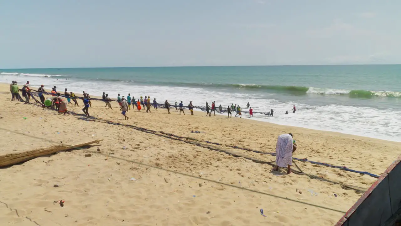 African people pulling fishing nets out of the sea