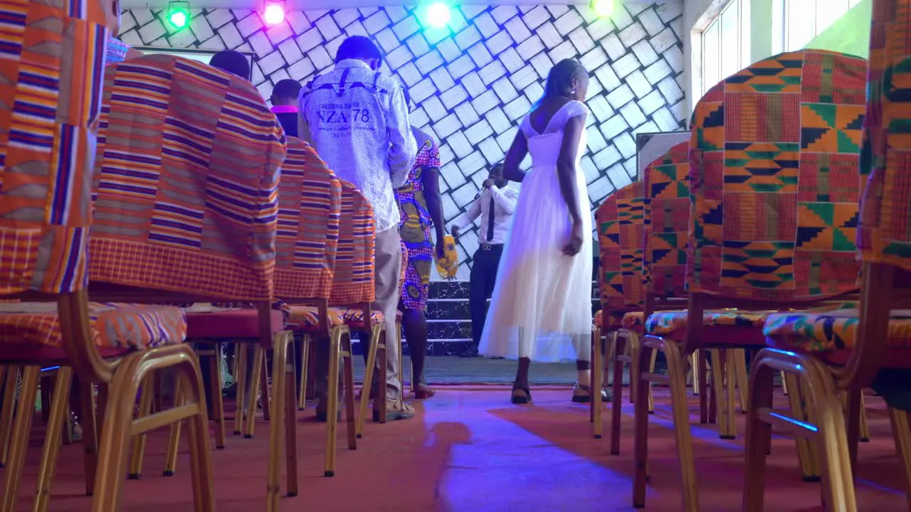 Low angle view of West african man singing in stage of a disco pub