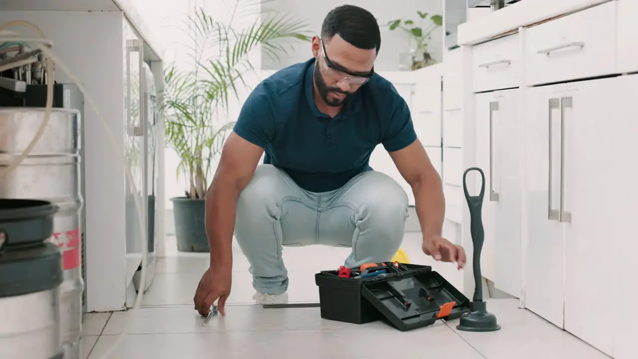 Plumber man tools and box on floor maintenance