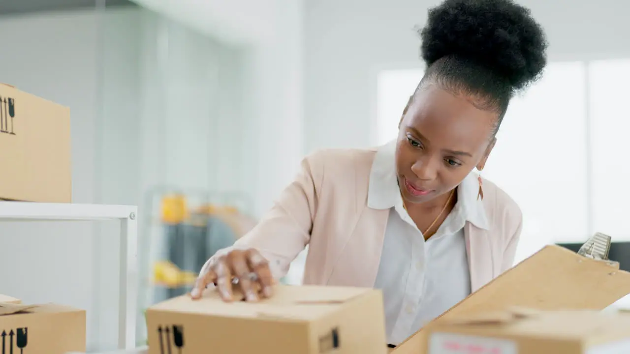 Black woman logistics and inspection on boxes