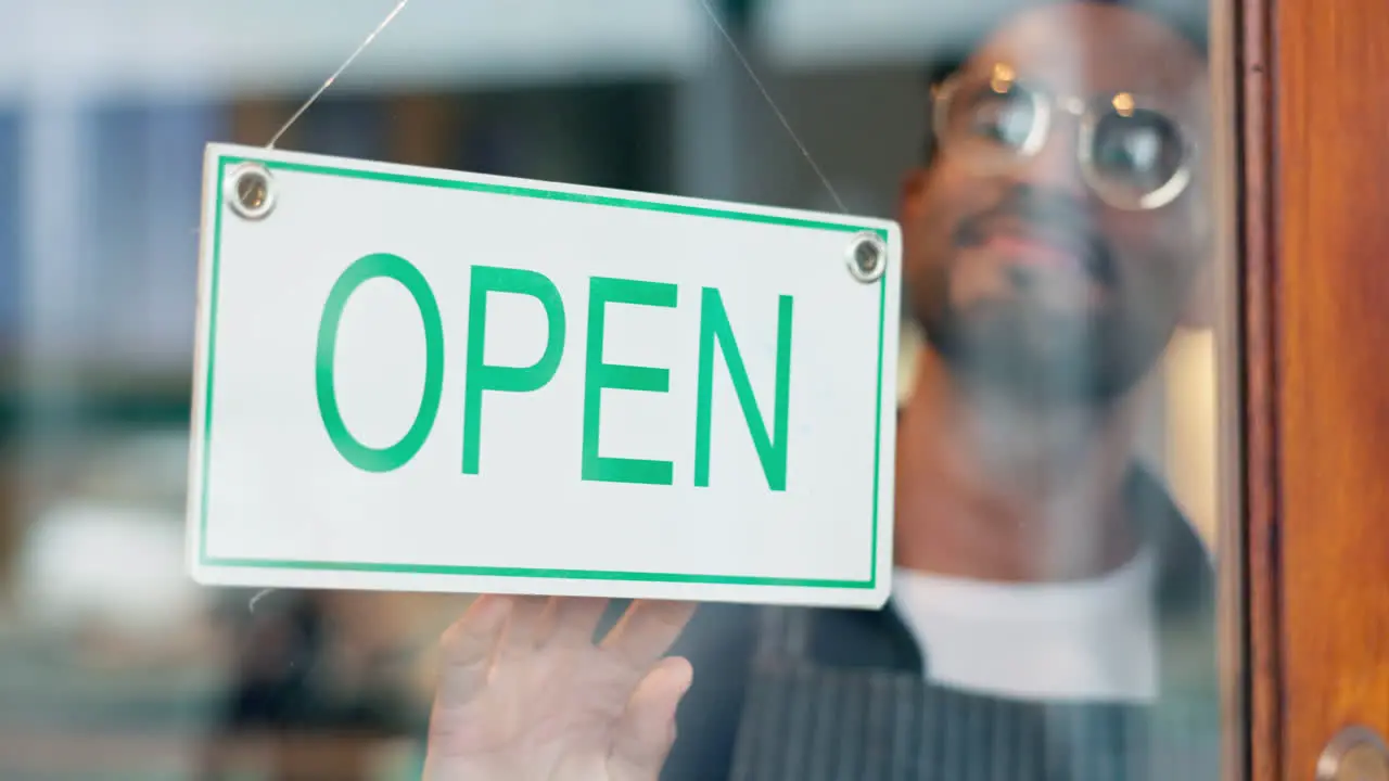 Open sign glass door and happy restaurant man