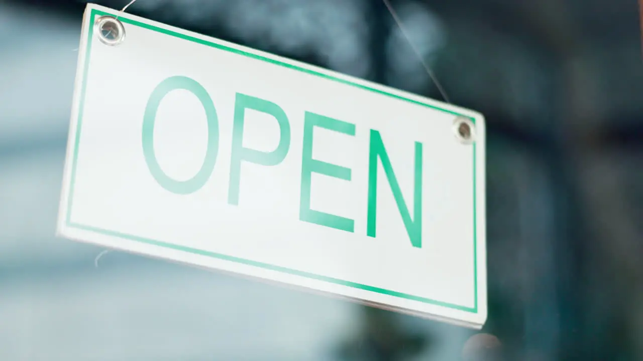 Open sign front door and happy restaurant man