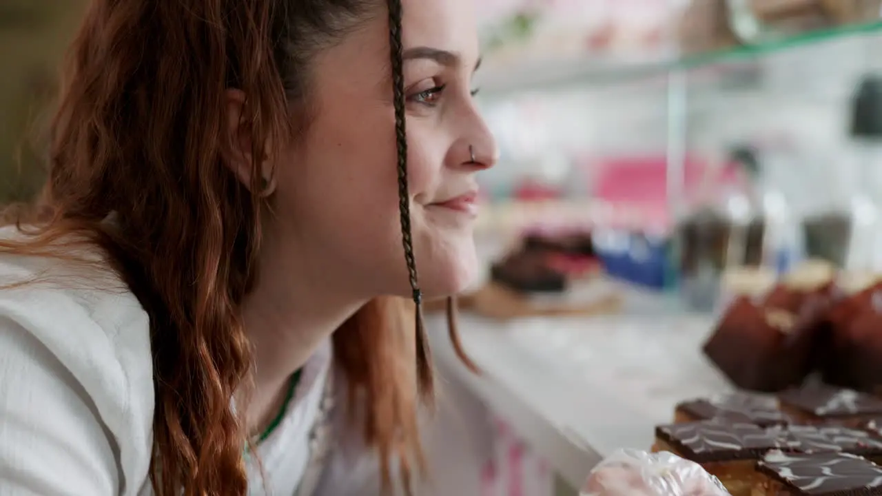 Cake display and bakery with woman in store