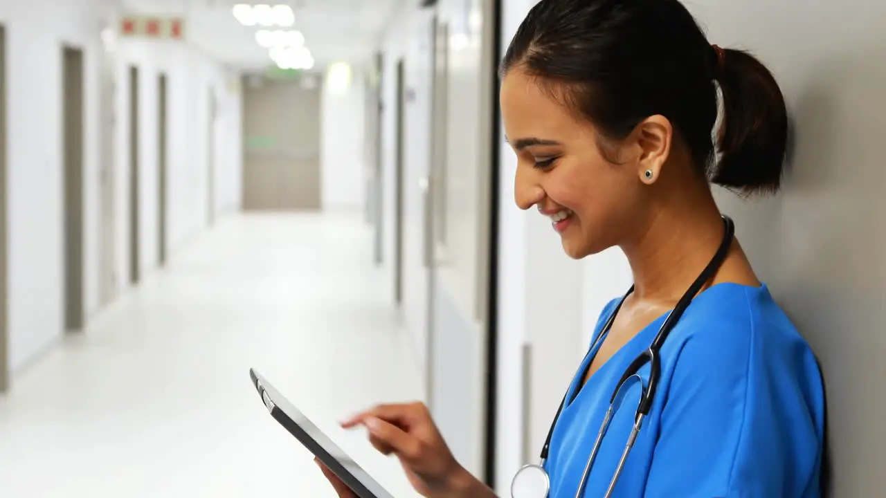 Female doctor using digital tablet in corridor