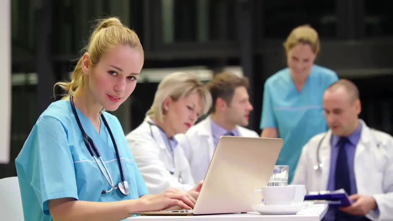 Nurse using laptop in conference room