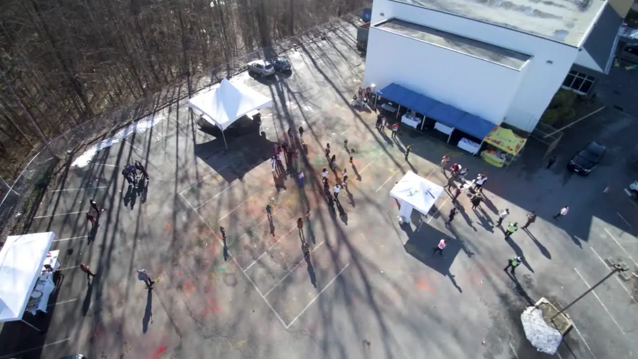 A Drone shot of a crowd in a parking lot