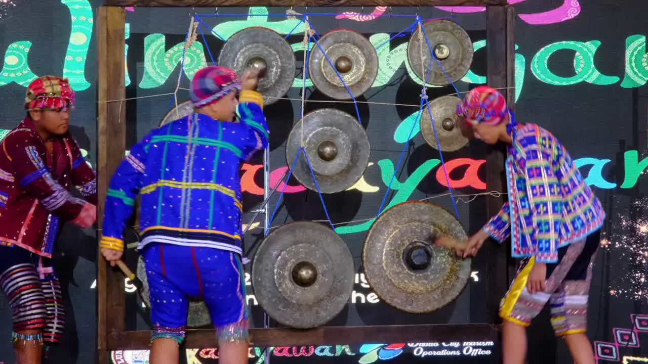 3 men performing music using the Agong of the Philippines