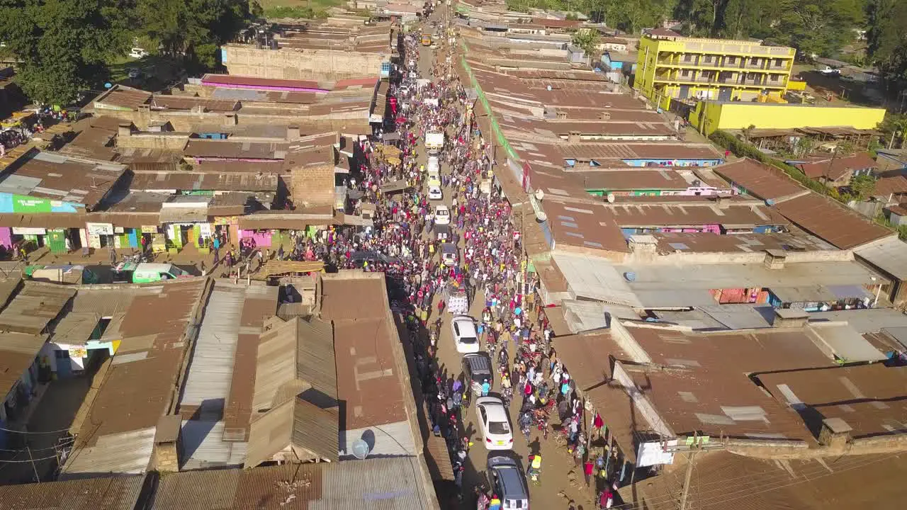 A Huge Gathering of People Following Politican Cars Aerail Wide Drone shot