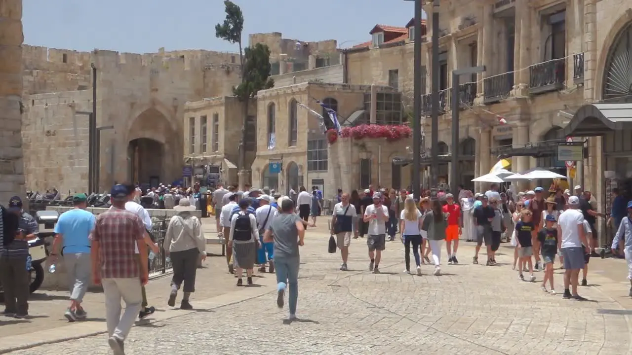 Tourists and locals on the street inside the city walls of Jerusalem Palestine