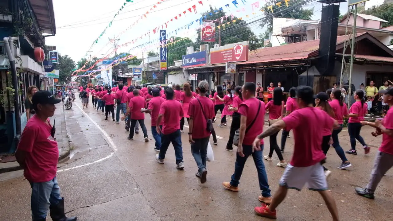 People singing and dancing on the streets of Coron Town during Pintados Kasadyaan festival celebrations in Coron Town in Palawan Philippines Southeast Asia