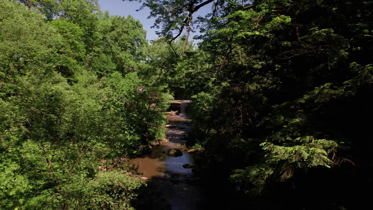 Aerial view of stone bridge over small river in the summer time