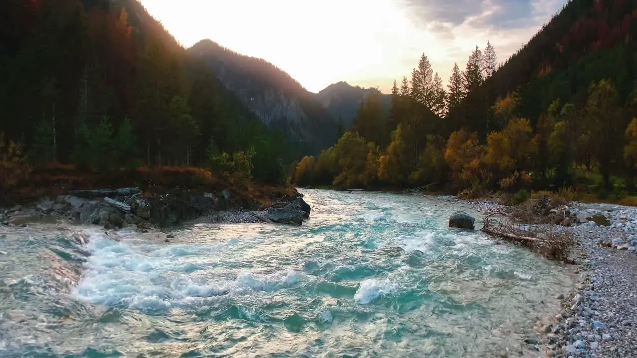 4K UHD seamless anamorphic cinema ratio video of a mountain river in the Austrian alps with a vibrant evening sky close to the German border in autumn