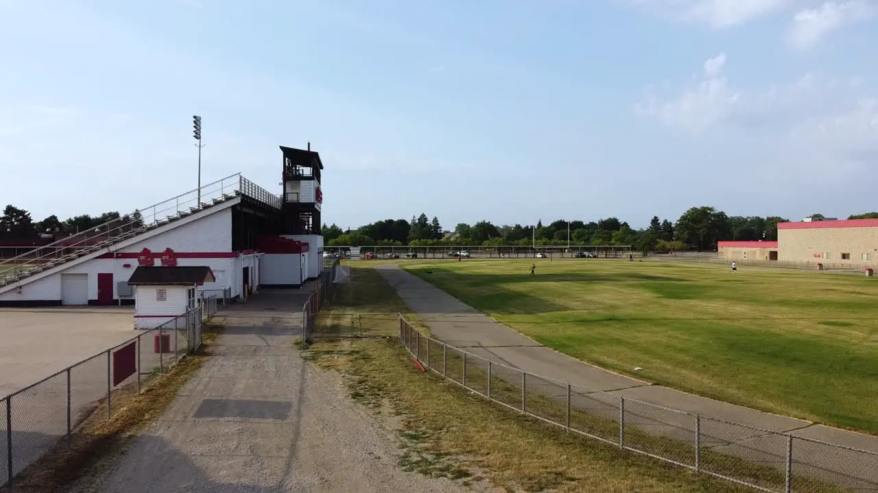 Drone tracking shot from low height of a beat down high school track