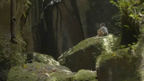 Long Shot of Couple Eating on Rocks in Bali