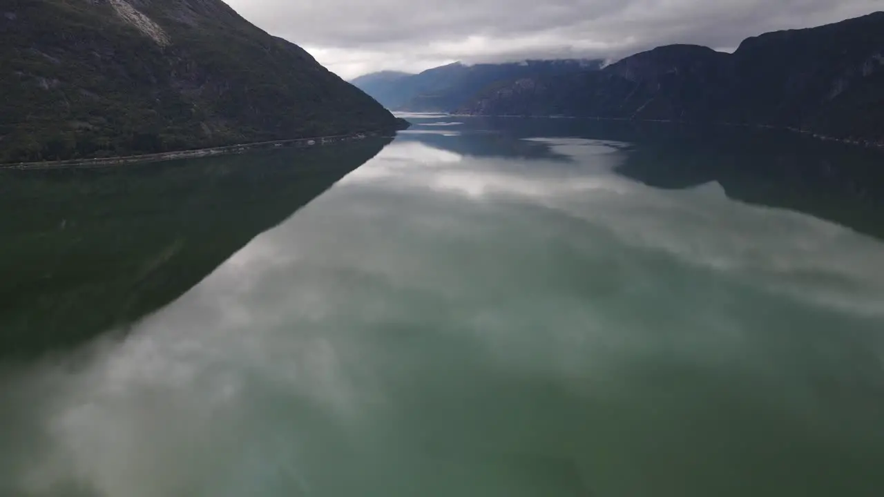 Drone footage of Eidfjord with low clouds and green water