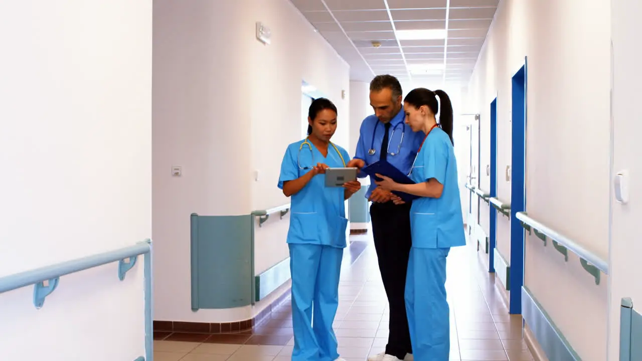 Doctor and nurses looking at clipboard