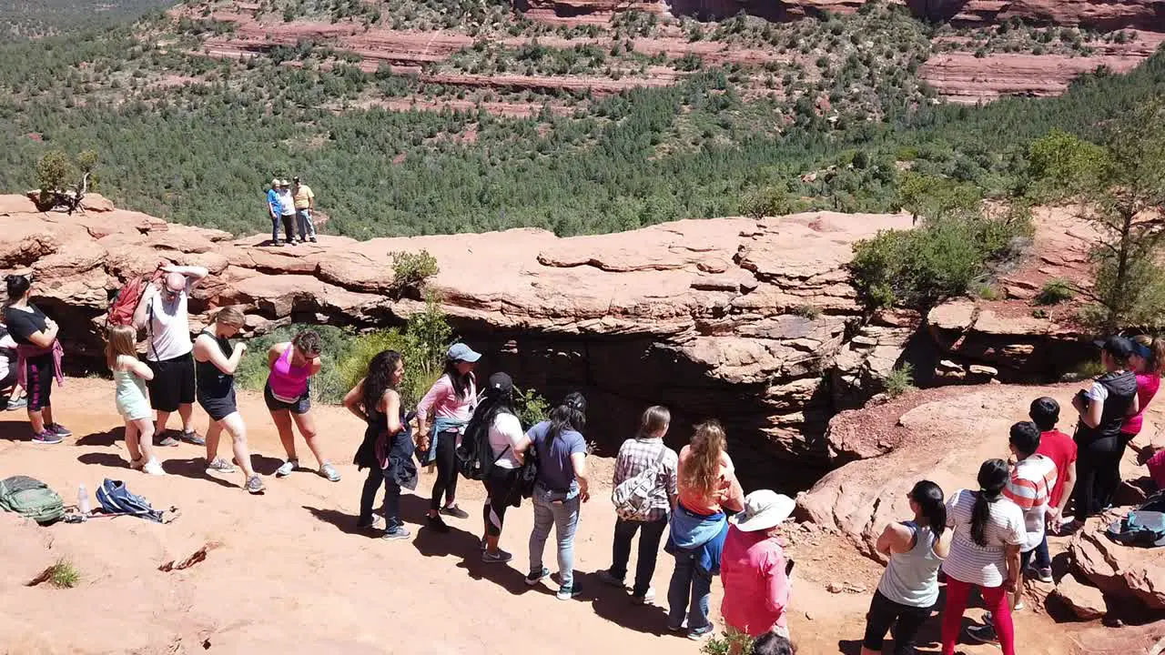 A crowd of people at Devil's Bridge in Coconino National Forest near Sedona Arizona