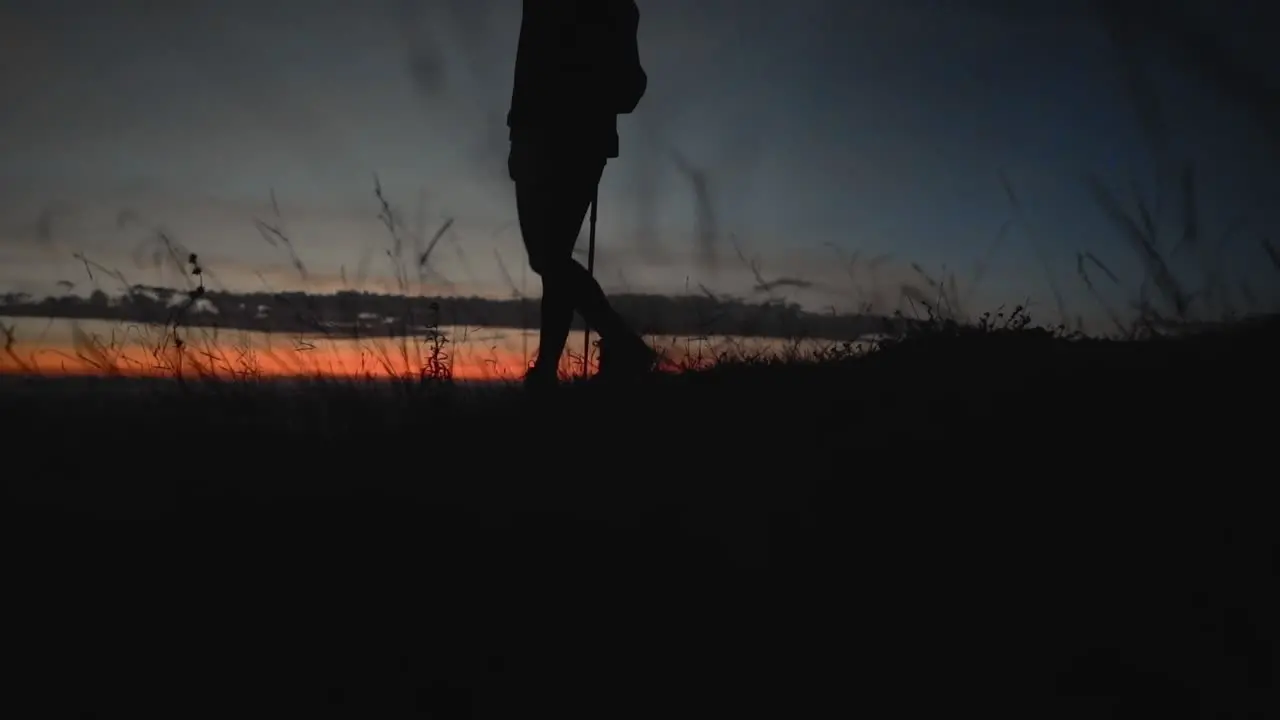 Hiker walking in slow motion during sunrise